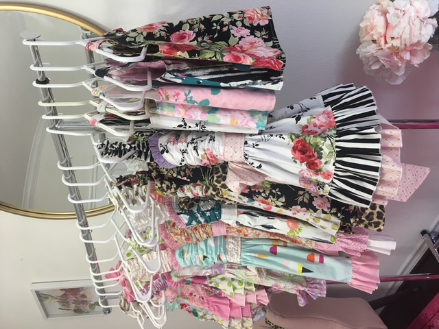 Rack of handmade boutique twirl dresses sewn from 100% quilting cotton fabric by the yard