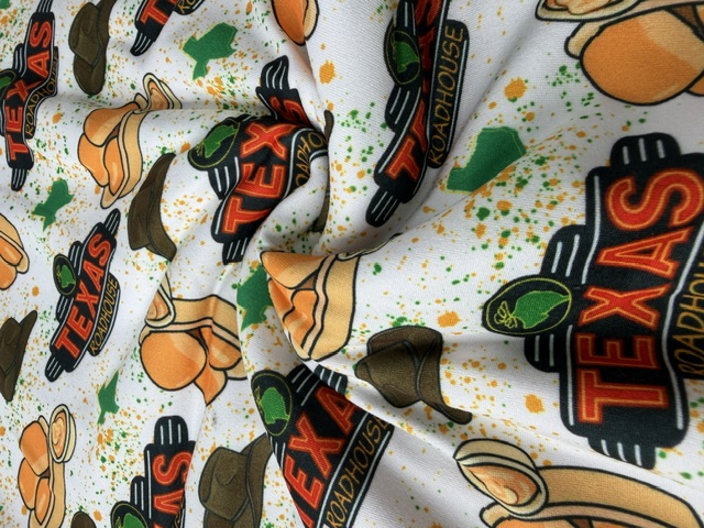 Texas Roadhouse novelty print fabric with cowboy hats and rolls