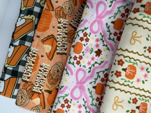 Photographed fall fabric prints — pumpkin pie, Momma's Pumpkin, pink bows and scalloped stripes