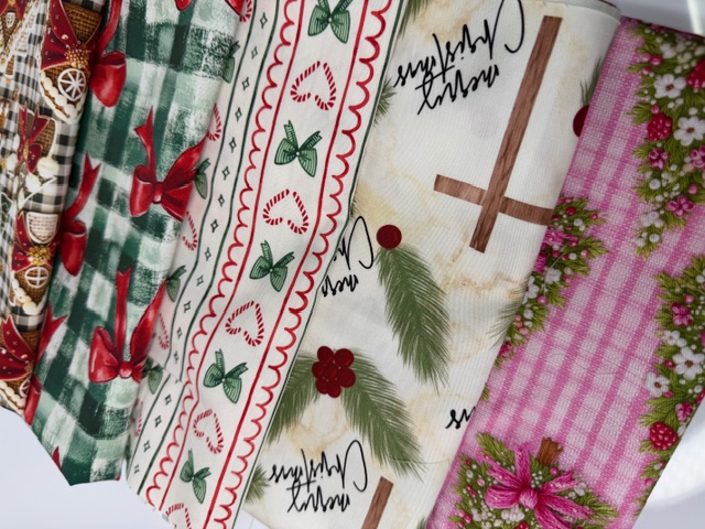 Photographed Christmas fabric prints — gingerbread, red bows, candy canes and wreaths