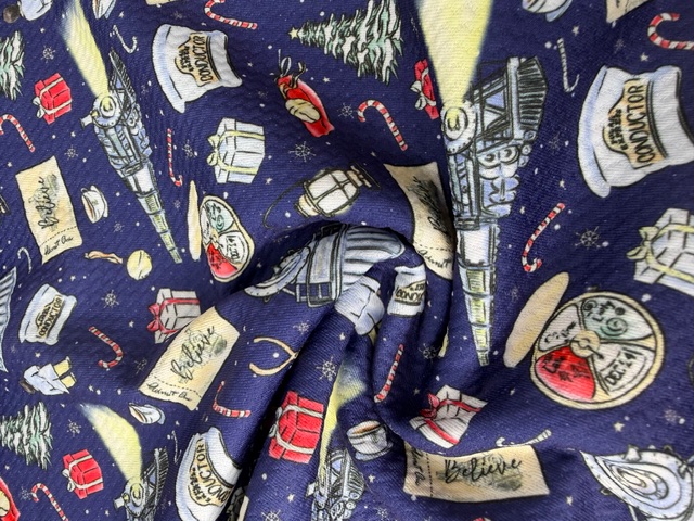 Photographed Polar Express Christmas fabric — steam trains and golden Believe tickets